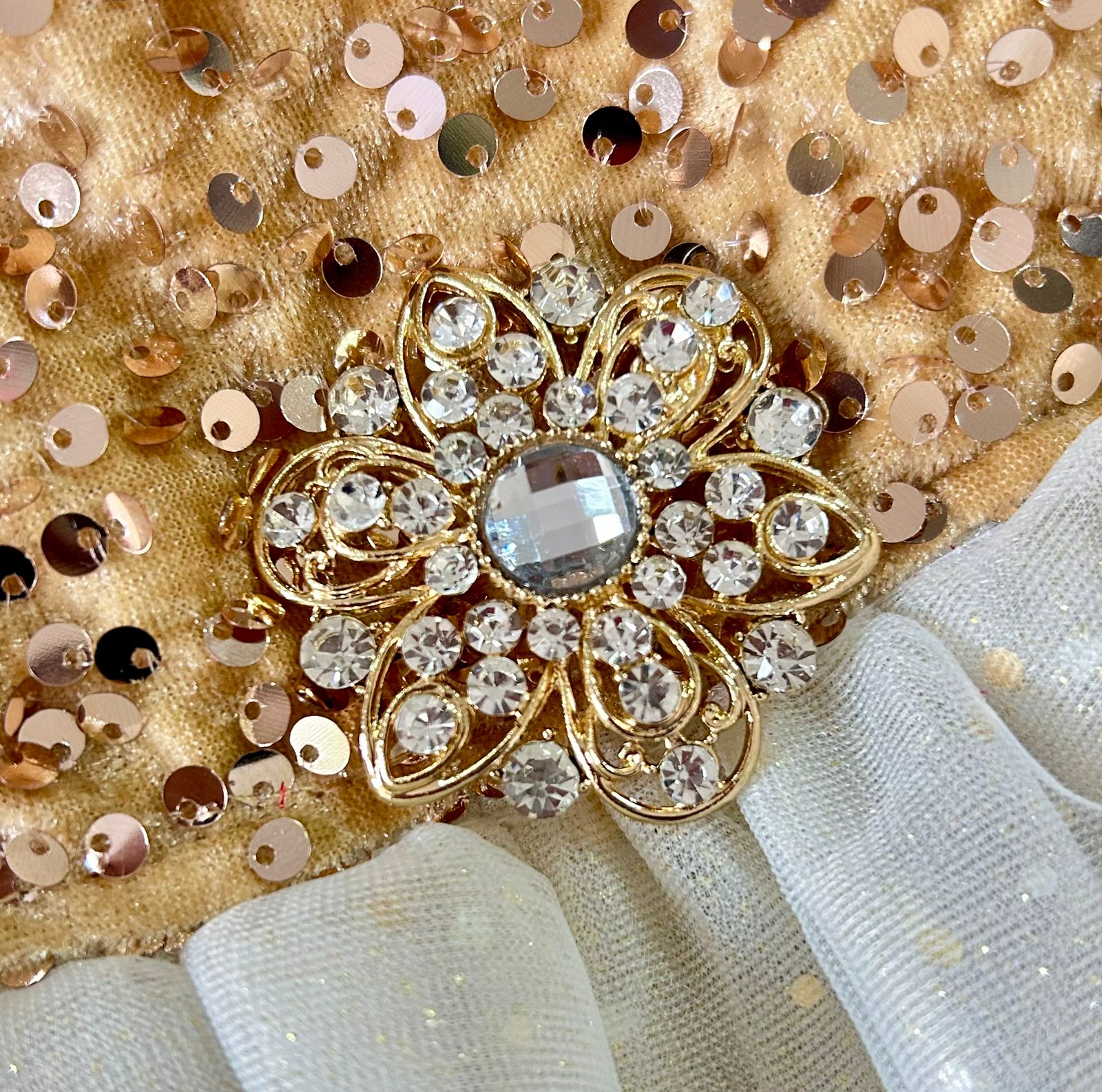 Vestido dorado para perritas con lentejuelas en la parte superior y falda de tul en tonos crema, fotografiado sobre fondo blanco para destacar su brillo.